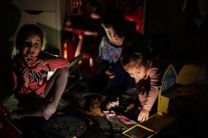 Children playing safely during a power outage blackout because of integrated technology by HQE Systems and their mass notification and emergency safety solutions.