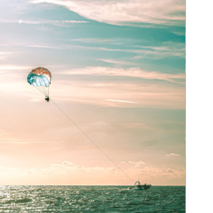 City of Clearwater sunset at the beach with parasailing.