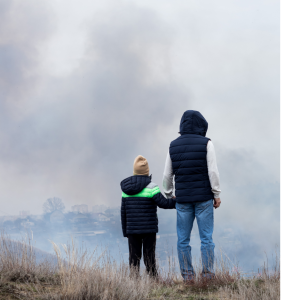 Family Watching wildfire on a hill in need of early waring sirens and electronic notifications for life safety.