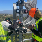 HQE Systems Staff on Field Installing Outdoor Sirens