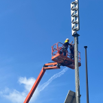 HQE Systems Worker Installing Sirens for emergency management and alerting needs.